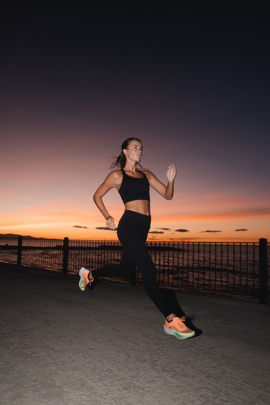 Woman in APRÍ lyocell activewear — leggings and sports bra — running outdoors