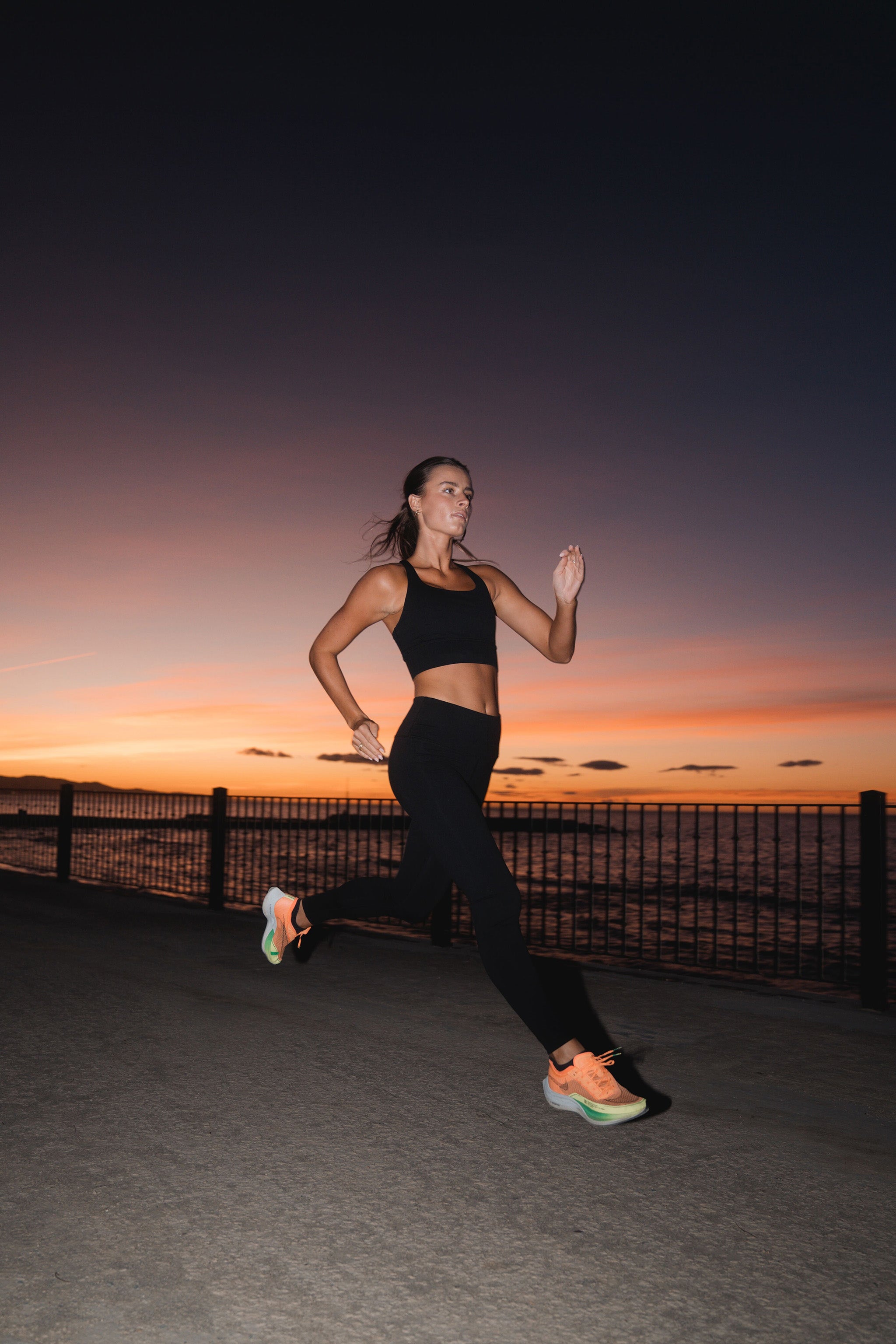 Woman in APRÍ lyocell activewear — leggings and sports bra — running outdoors