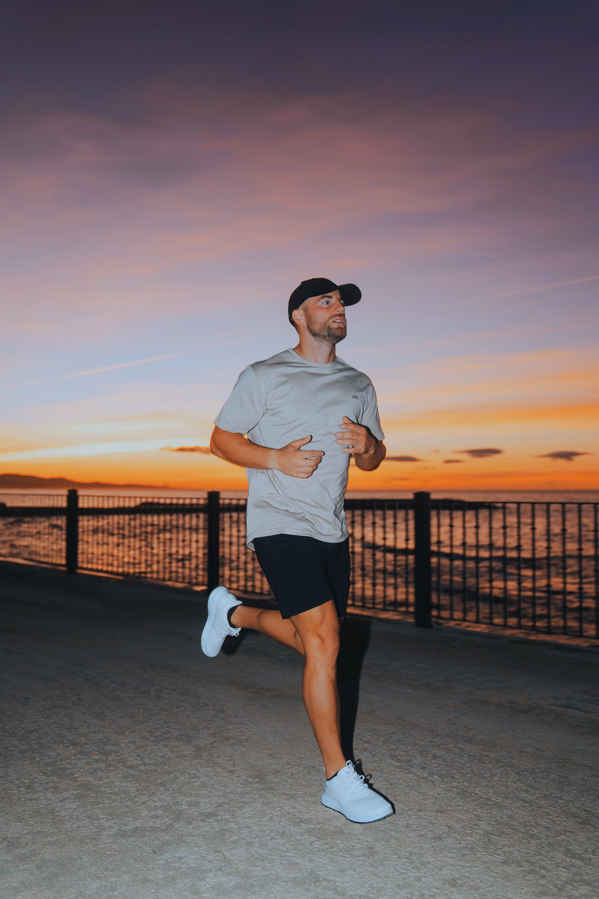 Man running on a path during sunset by the beach